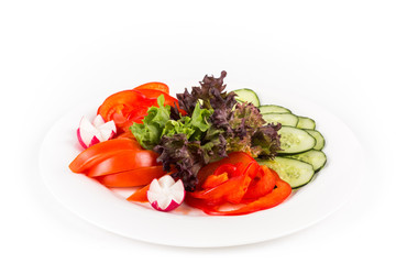 Sliced vegetables on a plate. Isolated on a white background.