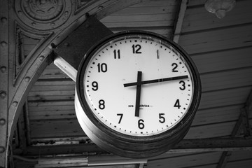 Clock in railway station in black and white