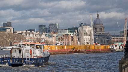Fototapeta premium Traffic on the river Thames, London, near Waterloo Bridge with St Paul’s cathedral in the background