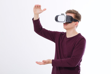 Excited young man in a VR headset, glasses . Virtual reality isolated on white background. Copy space and mock up
