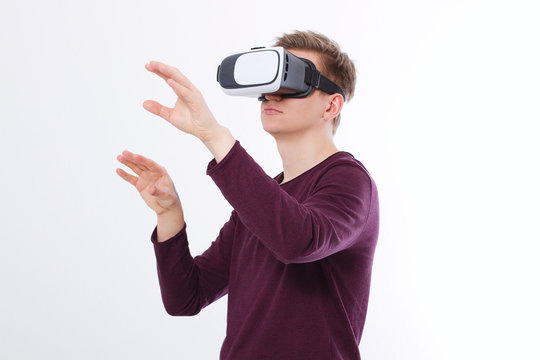 Excited young man in a VR headset, glasses. Virtual reality isolated on white background. Copy space and mock up