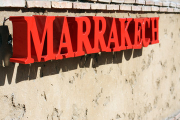 Red letters spelling "Marrakech" in the sun