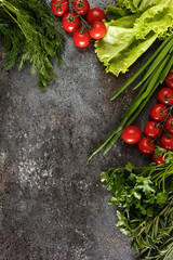 Fresh juicy vegetables with copy space on black background, top view.