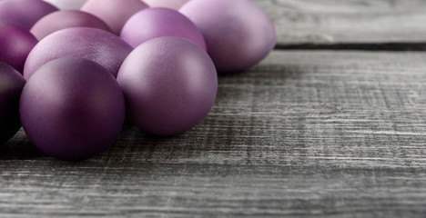 Easter eggs in fashionable colors on a gray wooden background
