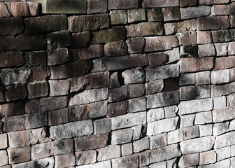 Discoloured brickworks made of criss-cross put bricks, with light-ray.