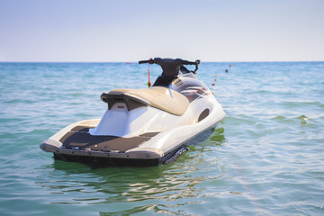 Naklejka premium Water motorcycle in the blue sea on clear sunny day. Water bike on waves of sea.