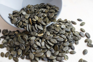 fresh pumpkin seeds scattered over table