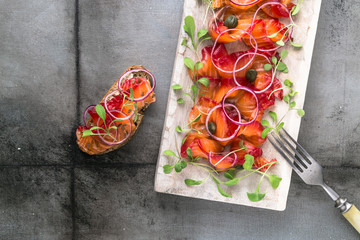 Cured scandinavian salmon or trout with onion and greens