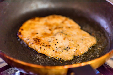 Chicken chop in frying pan close