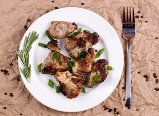 Shish kebab with onions and rosemary on a plate