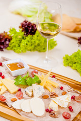 Fototapeta na wymiar Appetizer. Cheese platter with honey, nuts and grape