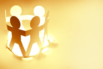 Paper chain team holding hands meeting