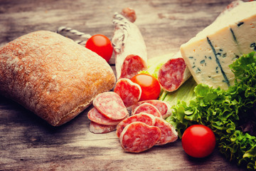 Sausage salami with noble mold, vegetables, cheese and bread bun