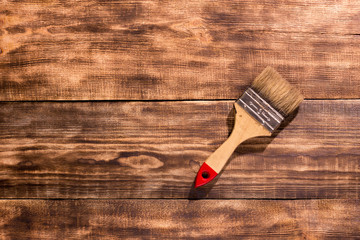 paintbrush on  burnt wooden background