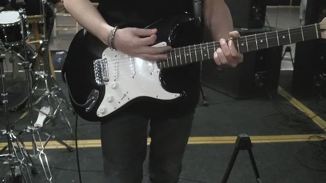 Musician plays on electro acoustic guitar on the concert show