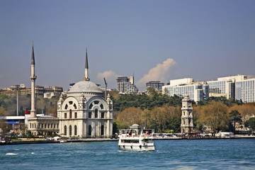 Fototapeta na wymiar Mosque Bezm-i Alem Valide Sultan (Dolmabahce) and clock tower in Istanbul. Turkey