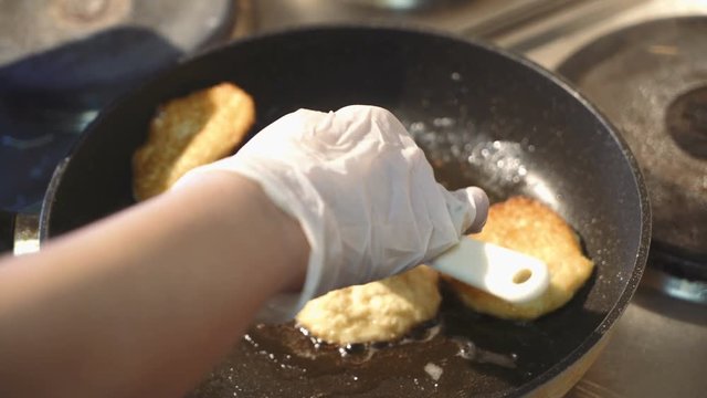 Preparation of golden crispy potato pancakes in a frying pan. Vegetable pancakes.