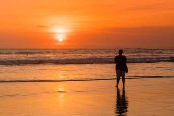 Fototapeta na wymiar Beach with people in sunset