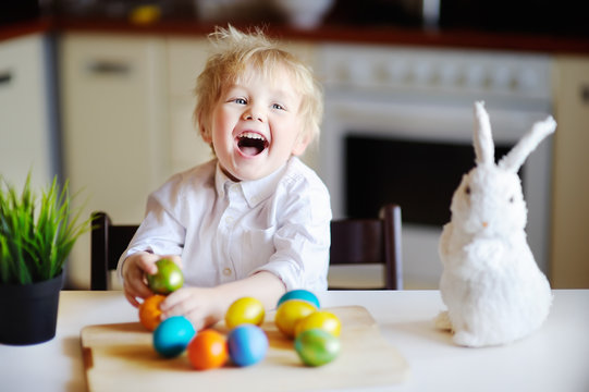 Cute toddler child hunting for easter egg on Easter day