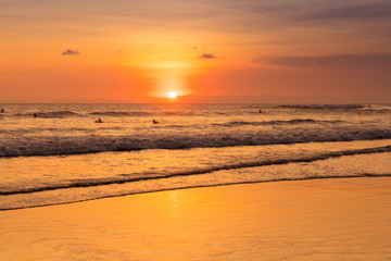 Beach with people in sunset