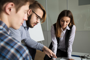 3 people work in the office, talking to, and address the issues of the company, smile and sign documents