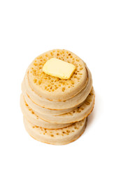 Hot  toasted crumpets with butter slice isolated on white