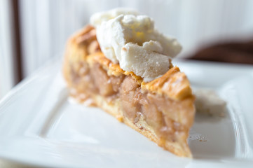 Hot apple pie with ice cream on top - concept on a white plate