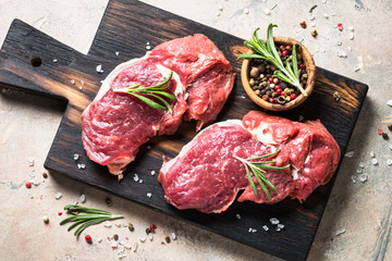 Raw beef steak with herbs.