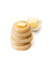 Hot  toasted crumpets with butter slice isolated on white