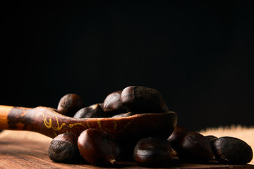 Roasted chestnuts in a wooden spoon