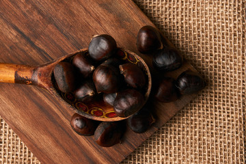 Roasted chestnuts in a wooden spoon