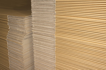 Stack of flat industrial folding cardboard packaging boxes