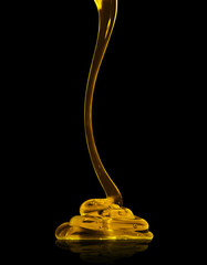 Transparent viscous liquid flows on a black background