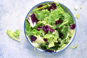 Mix salad leaves in a  bowl .Top view with copy space.