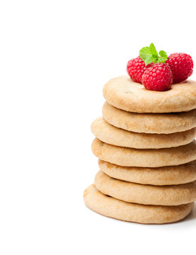 Stack  of homemade cookies with raspberries isolated on white background