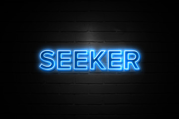 Seeker neon Sign on brickwall