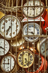 Old antique retro clocks in iron cage. Collection of vintage