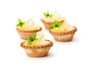 egg  custard tarts with lemon isolated on white