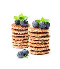 Stack  of mini dutch caramel waffles with blueberry isolated on white