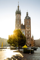 Old city center view with Adam Mickiewicz monument and St. Mary's Basilica in Krakow - obrazy, fototapety, plakaty