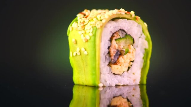 Sushi roll japanese food rotated over black background. 4K UHD video footage. 3840X2160