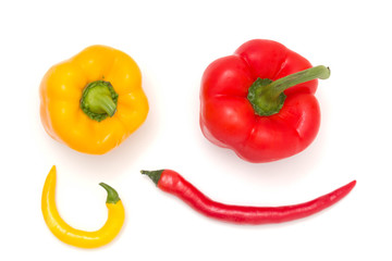 Mix of red and yellow peppers against a white background