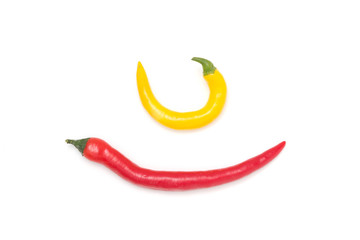 Mix of red and yellow peppers against a white background