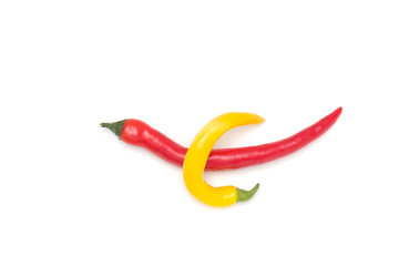 Mix of red and yellow peppers against a white background