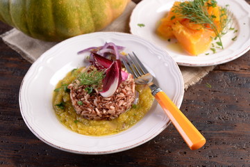 Dishes of risotto and cereals and pumpkin and herbs