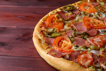 Delicious Hot Italian Pizza served on wooden table