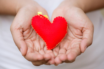 Obraz premium Woman giving red heart and love in valentine's day. People, charity, family and Love concept.