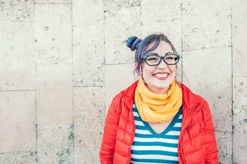 Happy beautiful fashion hipster woman with colorful hair laughing