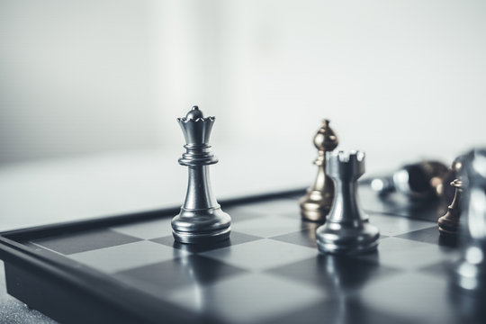 Investment Leadership Concept : The king chess piece with chess others nearby go down from floating board game concept of business ideas and competition and strategy plan success meaning.