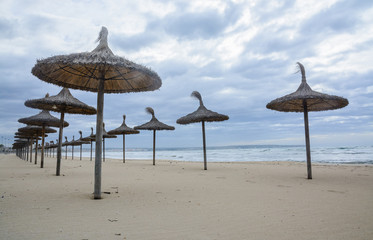 Straw parasols in front row